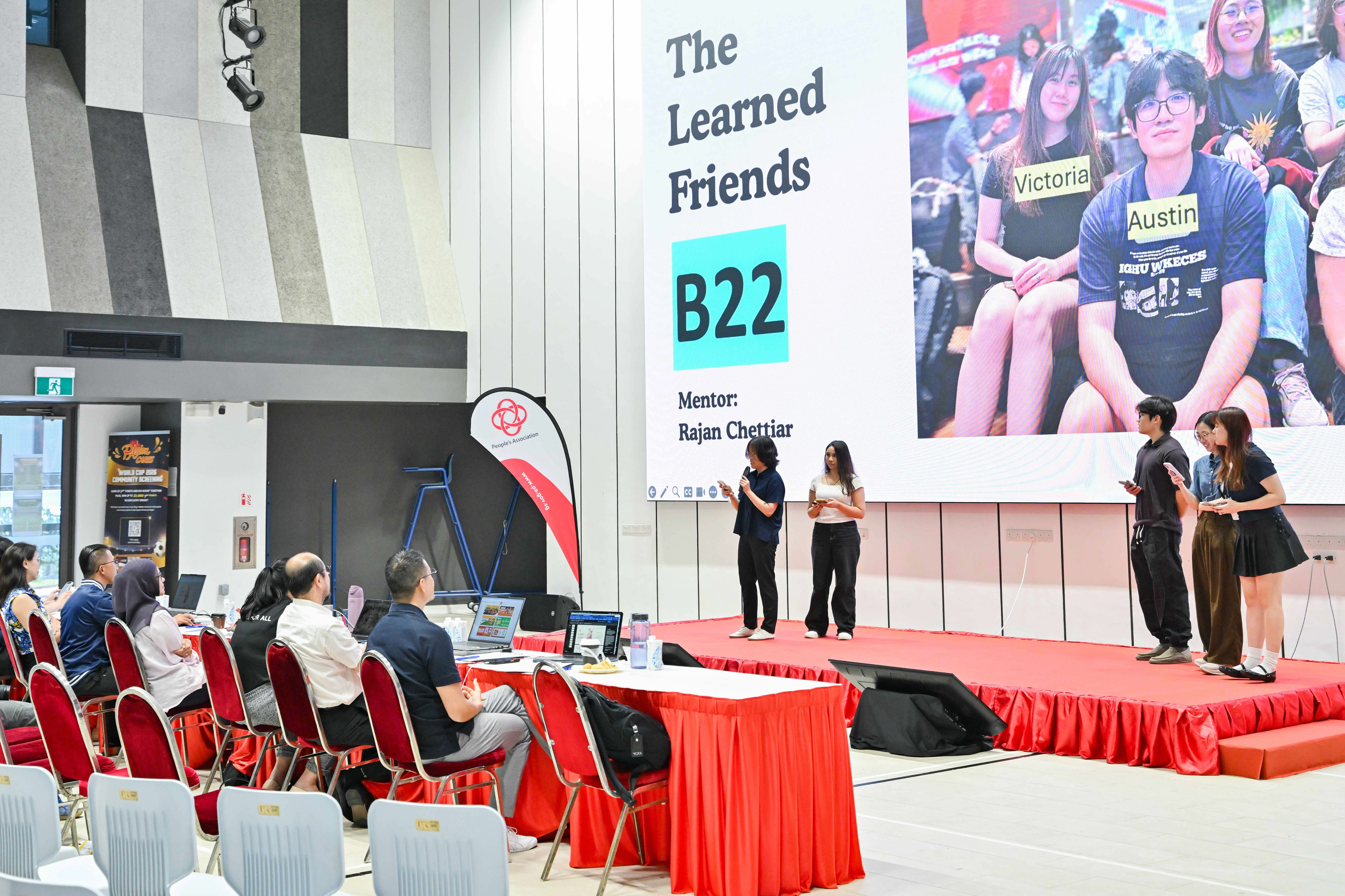 Five members of The Learned Friends giving a presentation